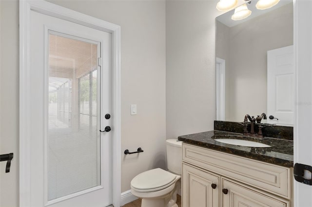 bathroom with vanity with extensive cabinet space and toilet