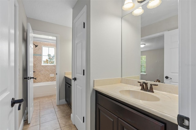 bathroom featuring tile flooring, plenty of natural light, and vanity