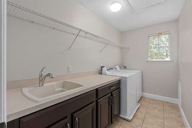 washroom featuring cabinets, washer hookup, washing machine and dryer, sink, and light tile floors