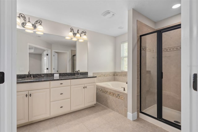 bathroom featuring tile flooring, large vanity, plus walk in shower, and dual sinks