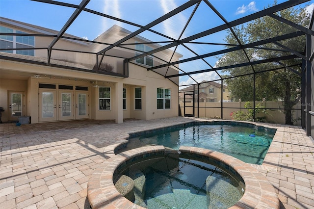 view of pool with ceiling fan, french doors, an in ground hot tub, a patio area, and a lanai