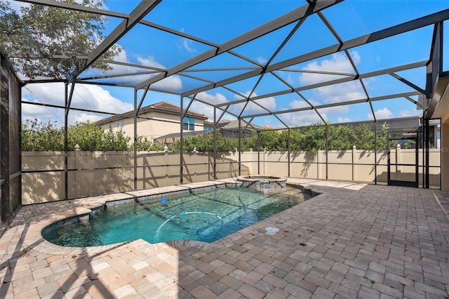 view of swimming pool featuring a patio and glass enclosure