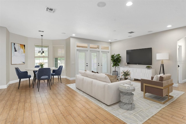 living room featuring light hardwood / wood-style floors and french doors