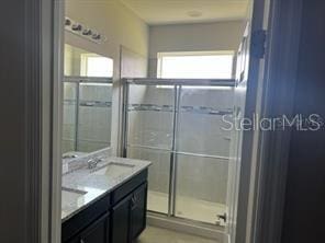 bathroom with vanity and walk in shower