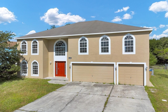 view of front of property featuring a front yard and a garage