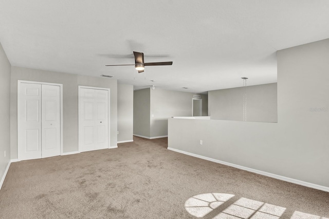 carpeted empty room with ceiling fan