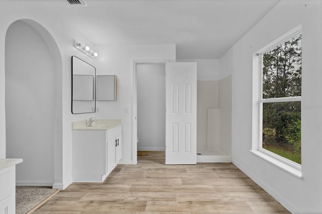 bathroom with vanity, hardwood / wood-style flooring, and toilet