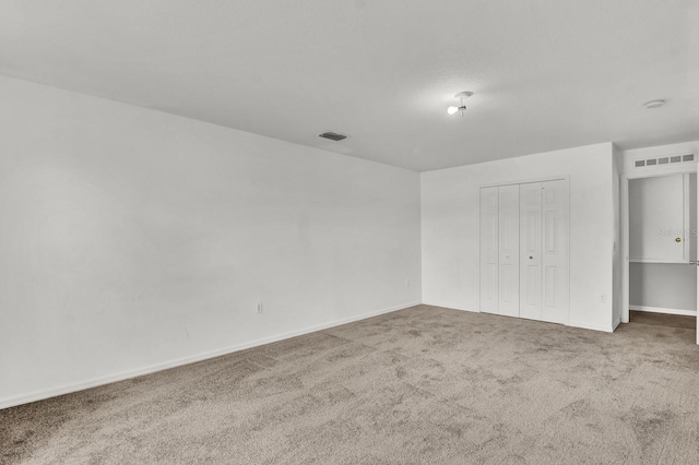 unfurnished bedroom with carpet flooring and a closet