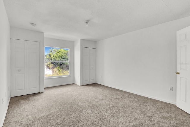 unfurnished bedroom with carpet floors and a textured ceiling