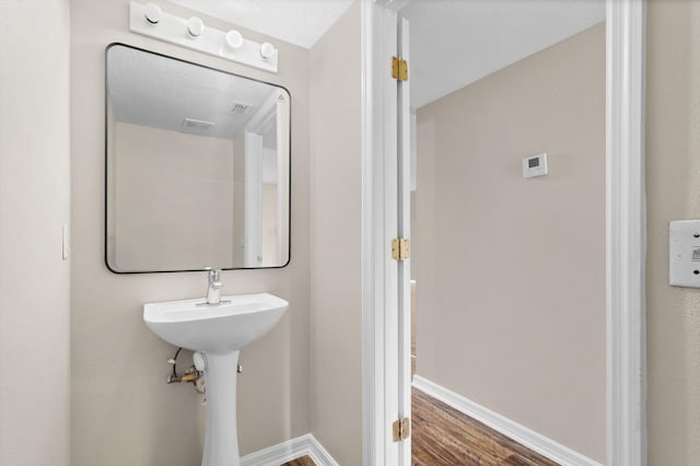 bathroom with hardwood / wood-style floors