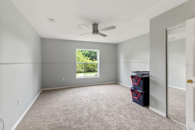 unfurnished room with carpet and ceiling fan