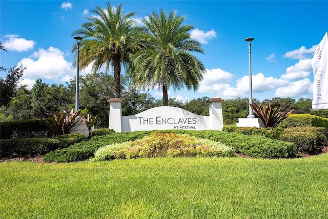 community / neighborhood sign with a lawn