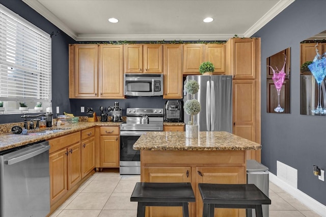 kitchen with appliances with stainless steel finishes, light stone counters, crown molding, and sink