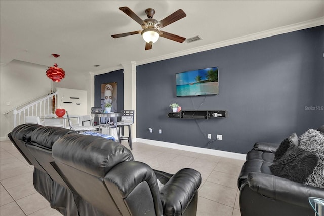 tiled living room with ceiling fan and ornamental molding