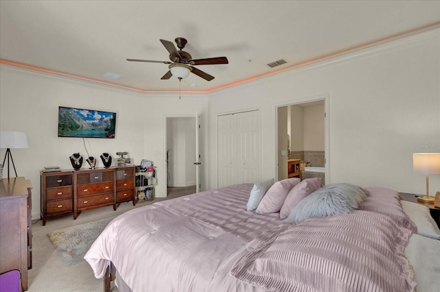 bedroom featuring ensuite bath, ceiling fan, ornamental molding, light colored carpet, and a closet