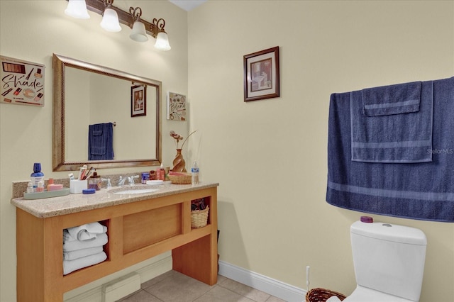 bathroom with tile patterned flooring, vanity, and toilet