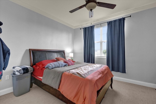 bedroom with ceiling fan, ornamental molding, and light carpet