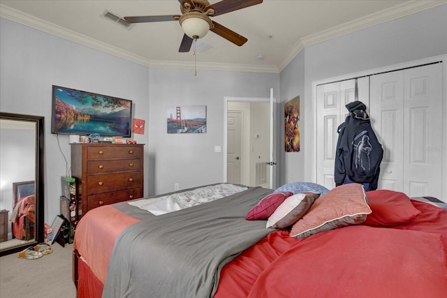 bedroom featuring carpet, ceiling fan, ornamental molding, and a closet