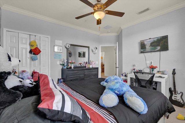 carpeted bedroom featuring ceiling fan, ornamental molding, and a closet