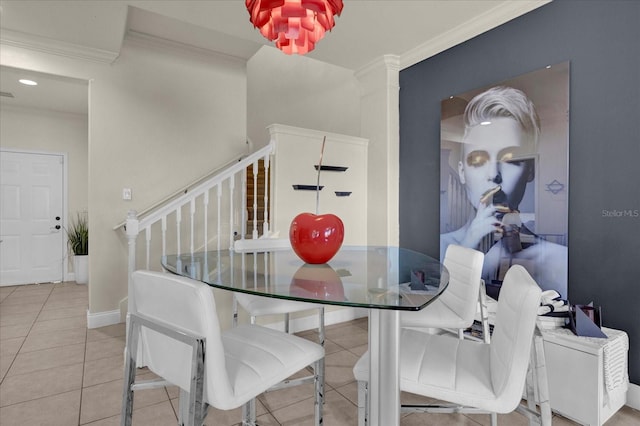 dining area with ornamental molding and light tile patterned floors