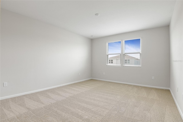 spare room with light colored carpet