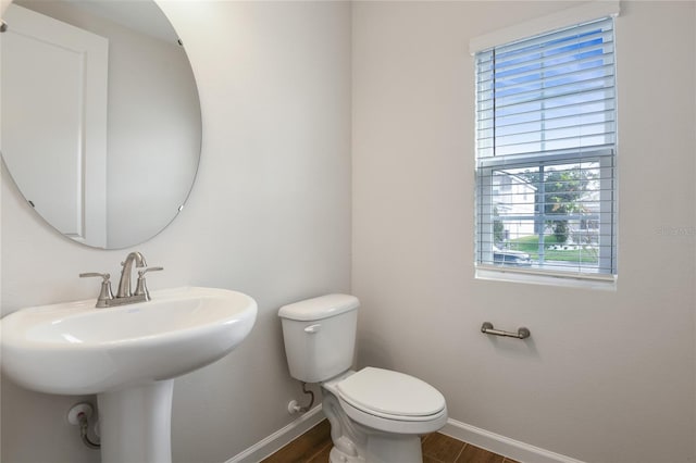 bathroom featuring hardwood / wood-style flooring, sink, and toilet