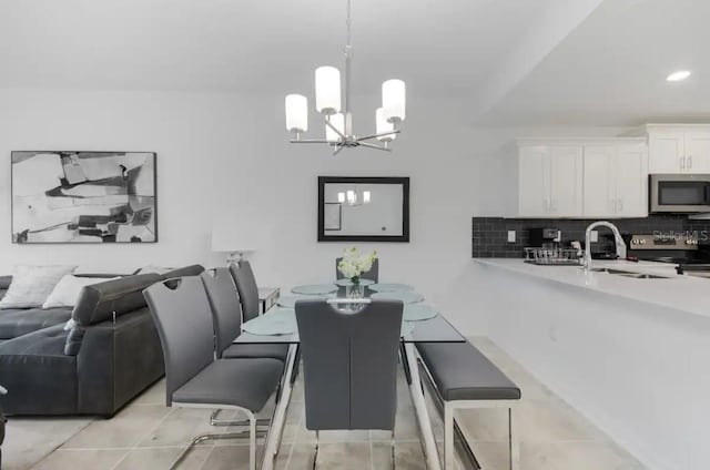 tiled dining area with an inviting chandelier and sink