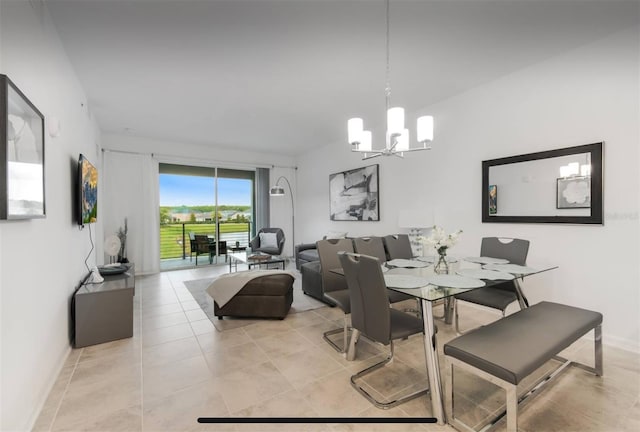 dining space featuring light tile patterned flooring and a notable chandelier