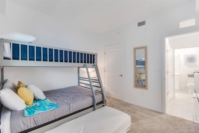 carpeted bedroom with ensuite bath