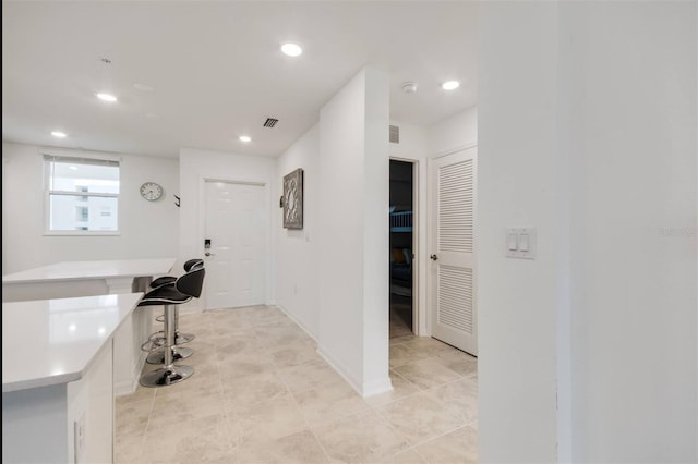 hallway featuring light tile patterned floors