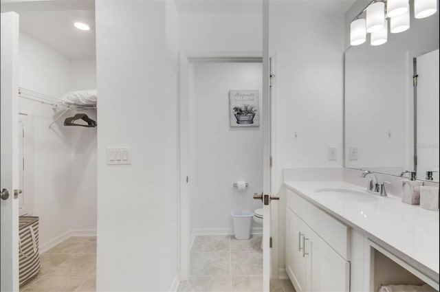 bathroom with vanity, tile patterned floors, and toilet