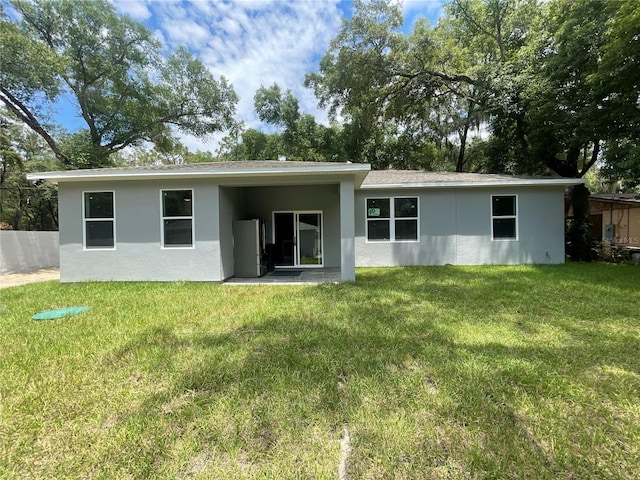 1730 Old Apopka Rd, Apopka, FL 32703 - rear view of house with stucco siding and a yard