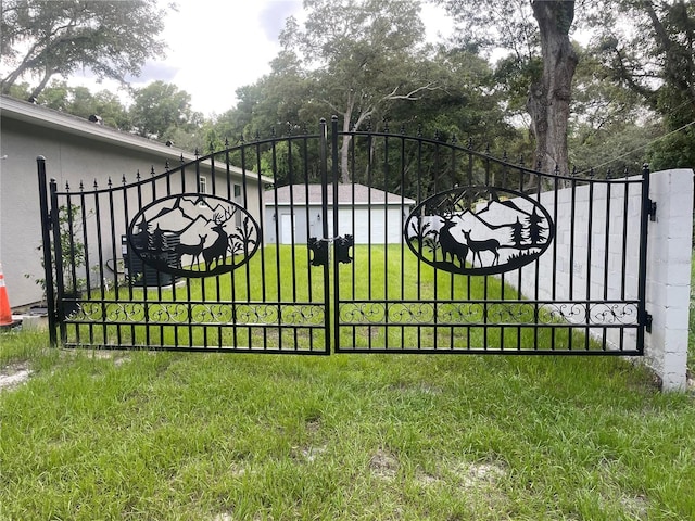 view of gate featuring a yard