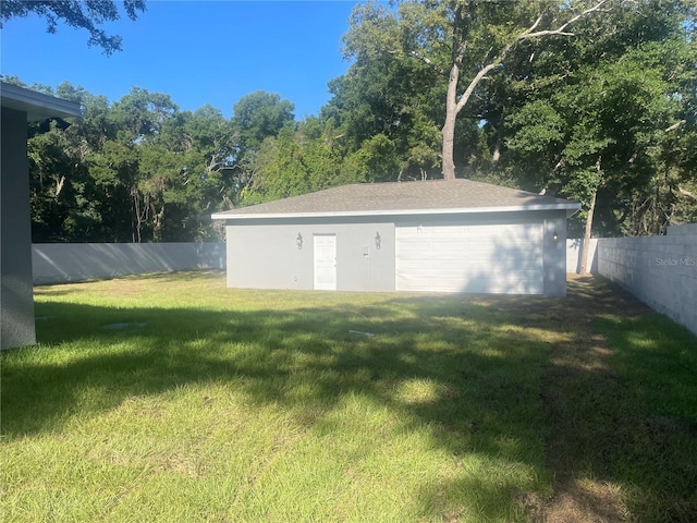 view of yard with a garage and an outdoor structure