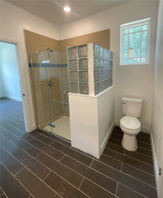 bathroom with an enclosed shower and toilet