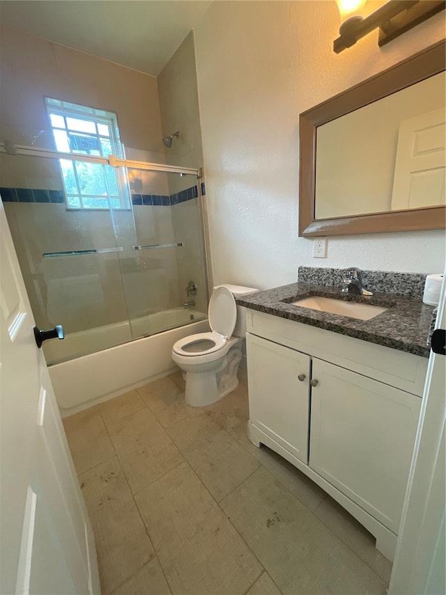 full bathroom with vanity, toilet, and enclosed tub / shower combo