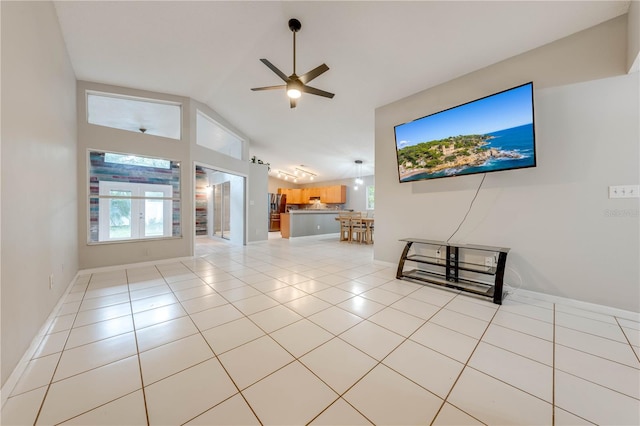 unfurnished living room featuring ceiling fan, lofted ceiling, and light tile patterned floors