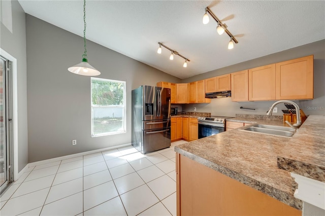 kitchen featuring lofted ceiling, hanging light fixtures, sink, light brown cabinetry, and appliances with stainless steel finishes