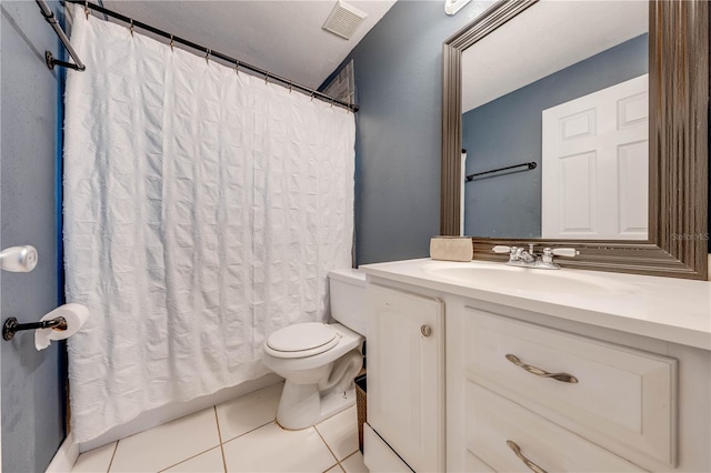 bathroom featuring tile patterned floors, vanity, and toilet