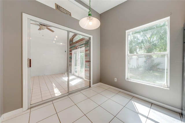 interior space with ceiling fan and light tile patterned flooring