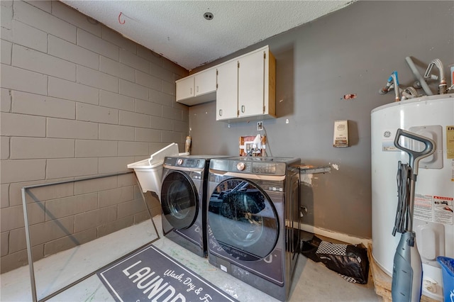 washroom with cabinets, independent washer and dryer, a textured ceiling, and water heater