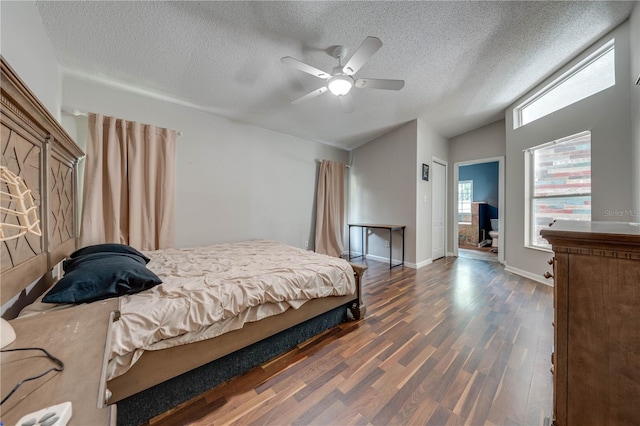 bedroom featuring a textured ceiling, ceiling fan, dark wood-type flooring, and vaulted ceiling