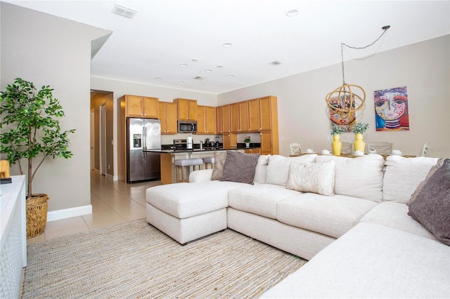 tiled living room with an inviting chandelier