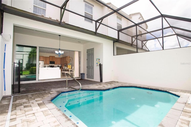 view of pool featuring glass enclosure and a patio area