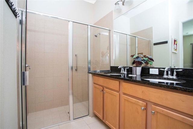 bathroom with vanity, an enclosed shower, and tile patterned flooring