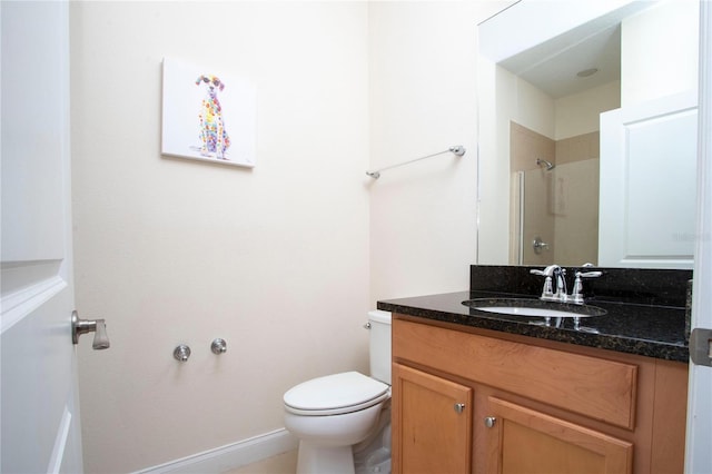 bathroom featuring vanity, toilet, and a shower