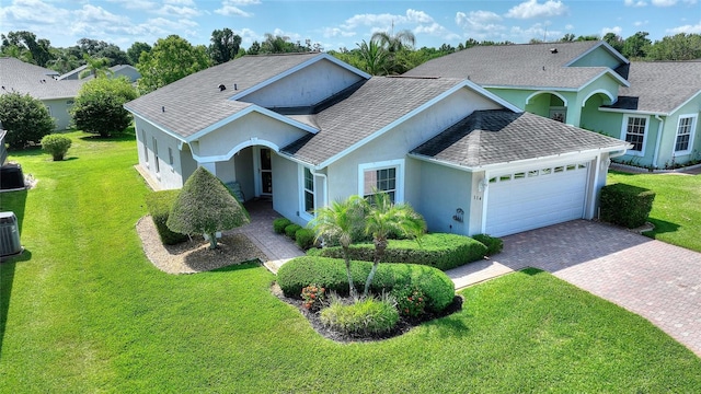 view of front of property with cooling unit, a front yard, and a garage