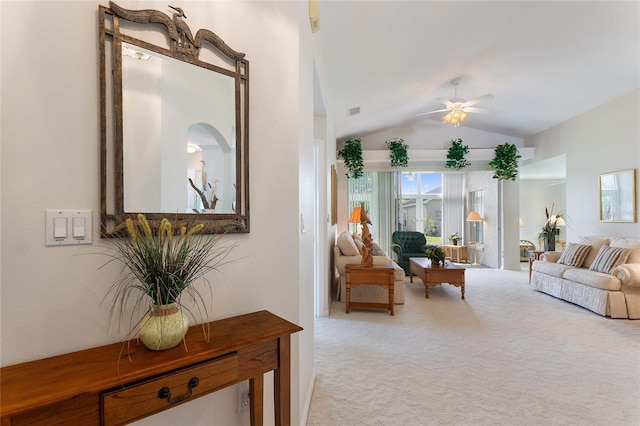 interior space with light colored carpet, ceiling fan, and lofted ceiling