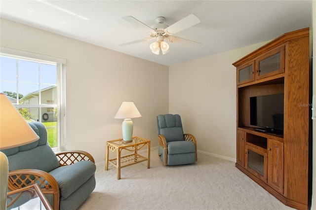 sitting room with light carpet and ceiling fan