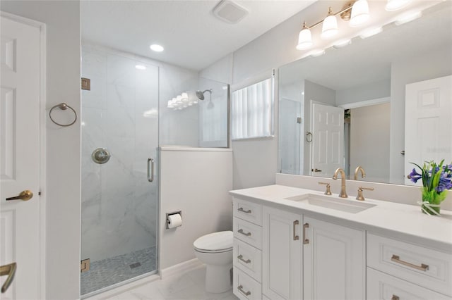 bathroom featuring vanity, toilet, and an enclosed shower